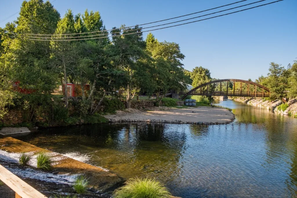 Wooden bridge and small beach on the river Ceira